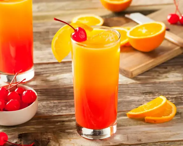 Sok z pomarańczy z czym łączyć? Ten drink, udekorowany wiśnią i pomarańczą, wygląda pysznie. Idealny na lato!